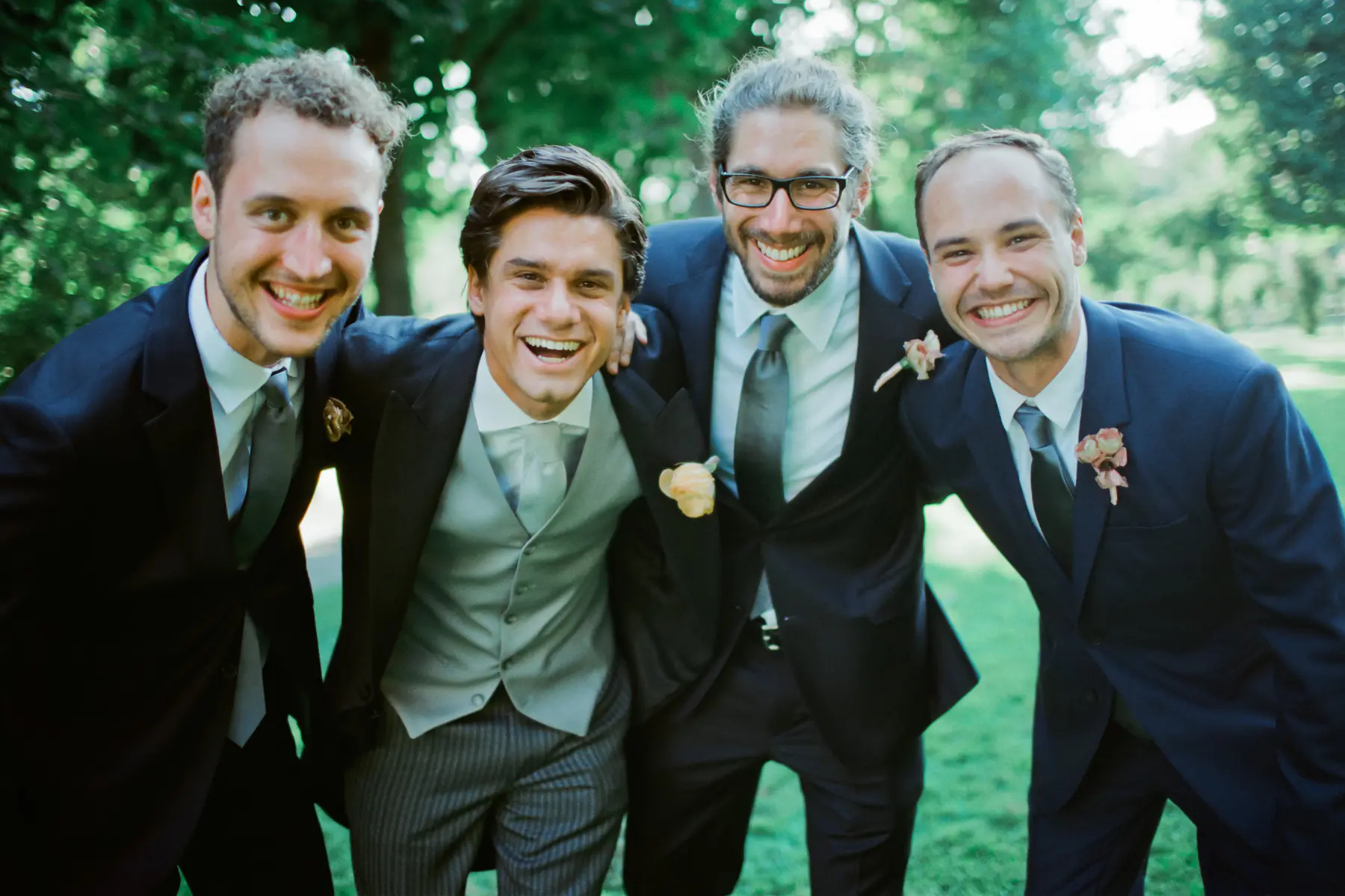 Groom and best man posing at a wedding, captured on Fujifilm 400H for authentic colors and airy film aesthetic.