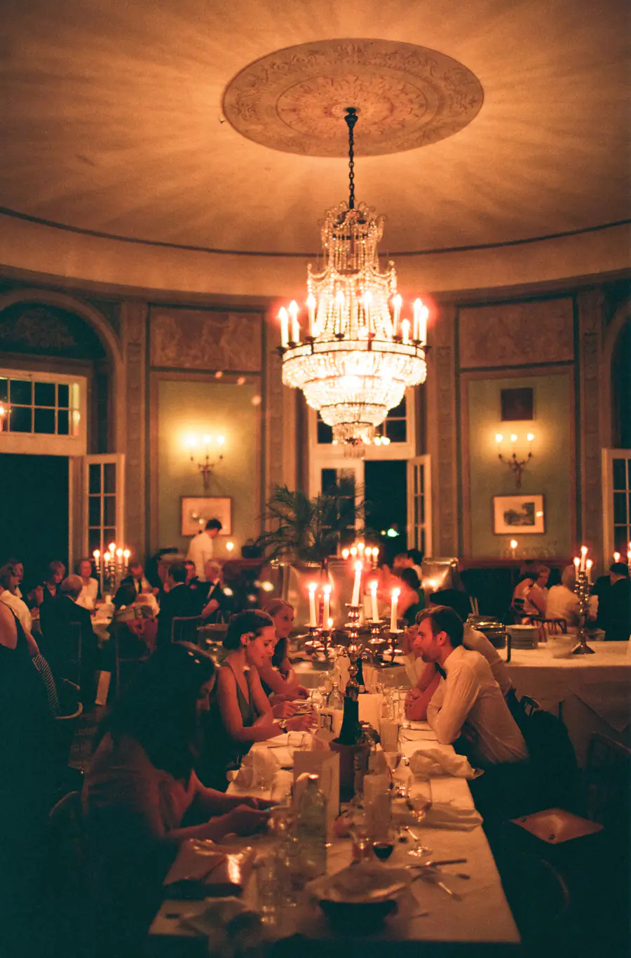 Wedding Evening dinner captured on Kodak Portra 800 film – natural light photography. Lavishly decorated room in Lusthaus in Vienna