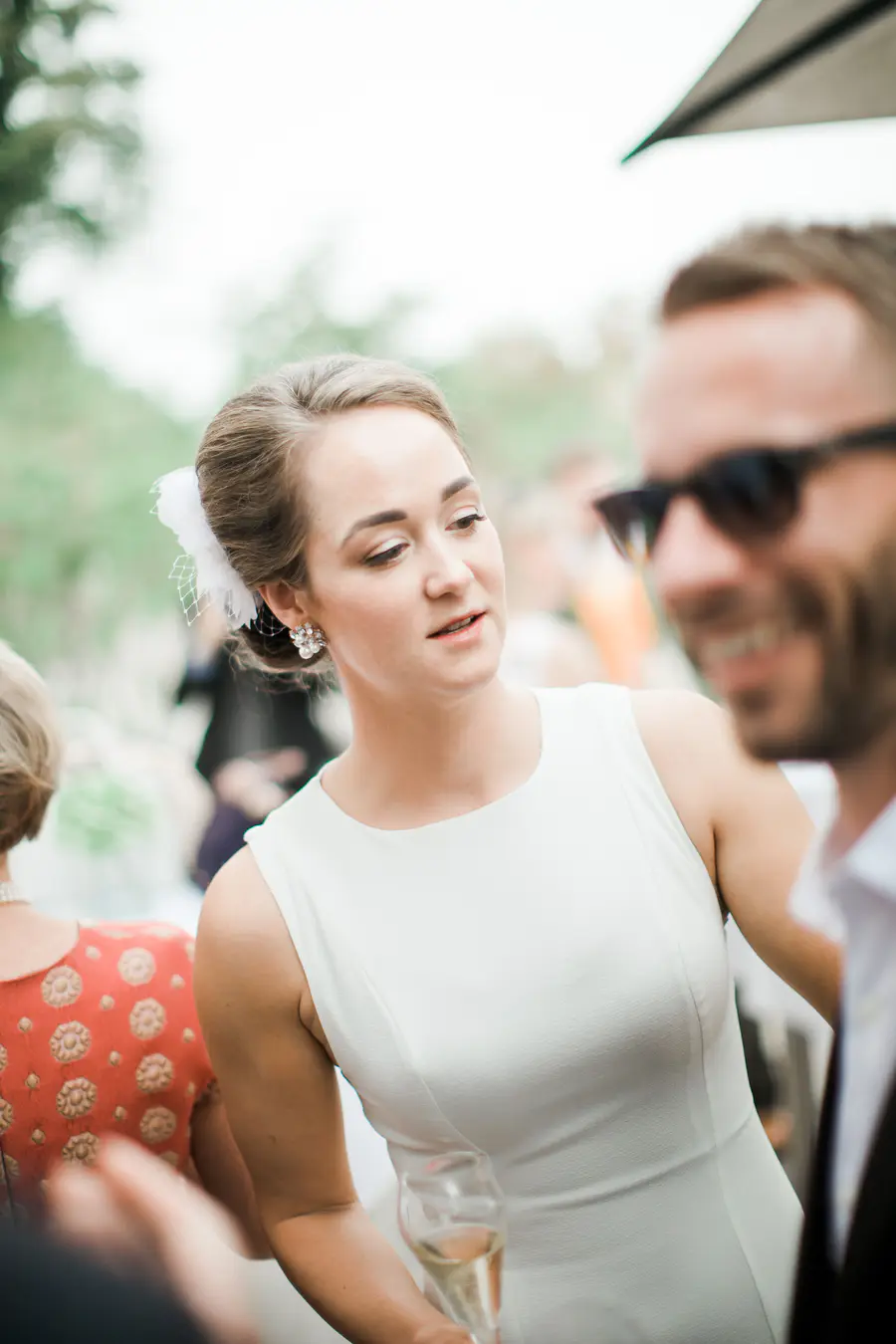 n elegant and celebratory shot of the bride holding a champagne glass, capturing the sophisticated yet joyful atmosphere of the wedding reception.