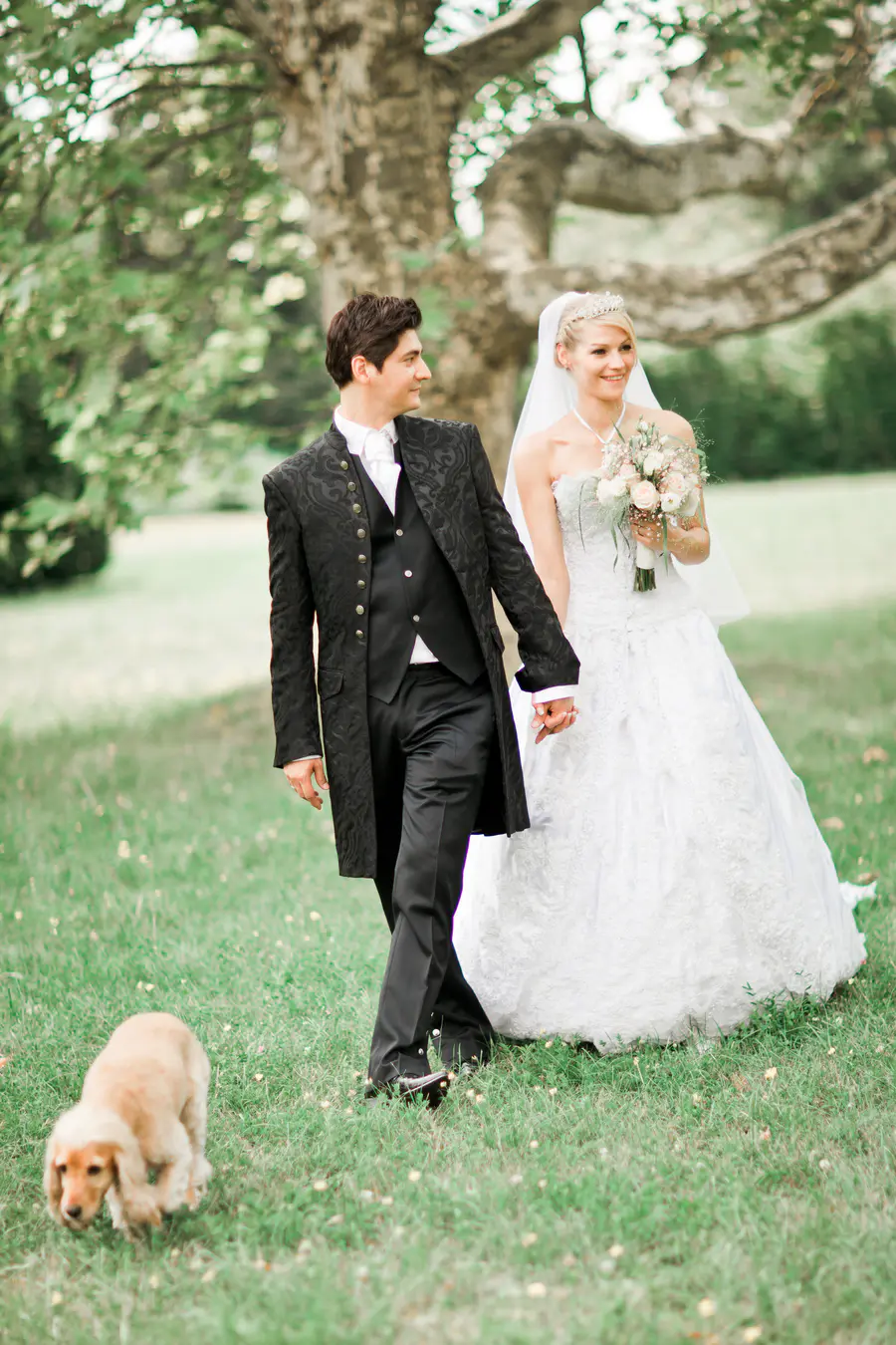 Bride and groom posiong in part at Schloss Hetzendorf