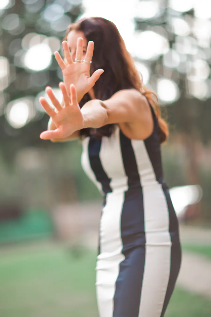 Young woman making gesto, protecting hersefl from camera
