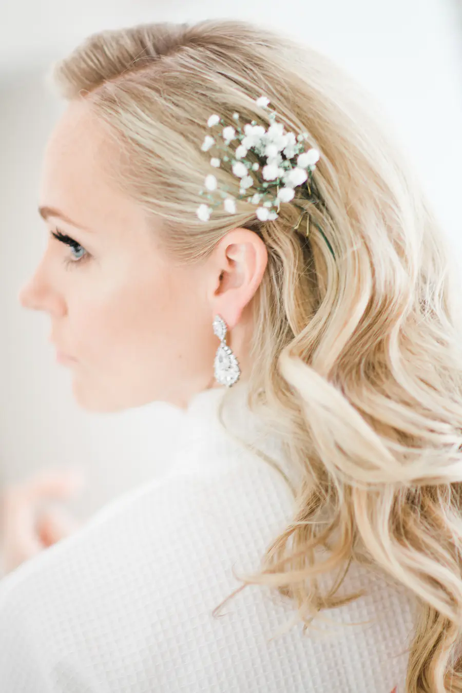 Beautiful bride in a robe during morning preparations at Art Hotel Kastiel, candid wedding photography Slovakia.