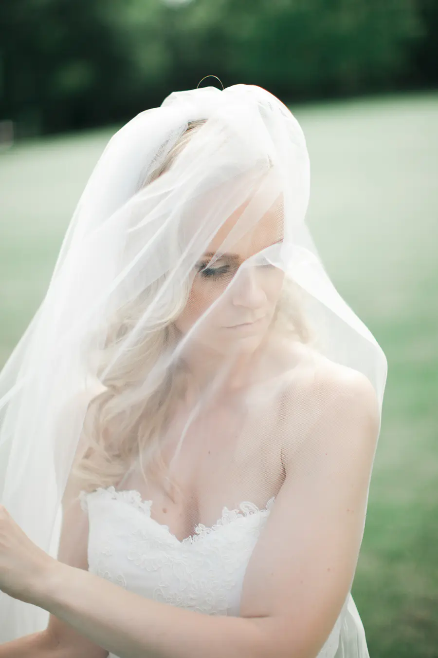 Close-up artistic shot of a bride under the bride's veil, romantic wedding style.