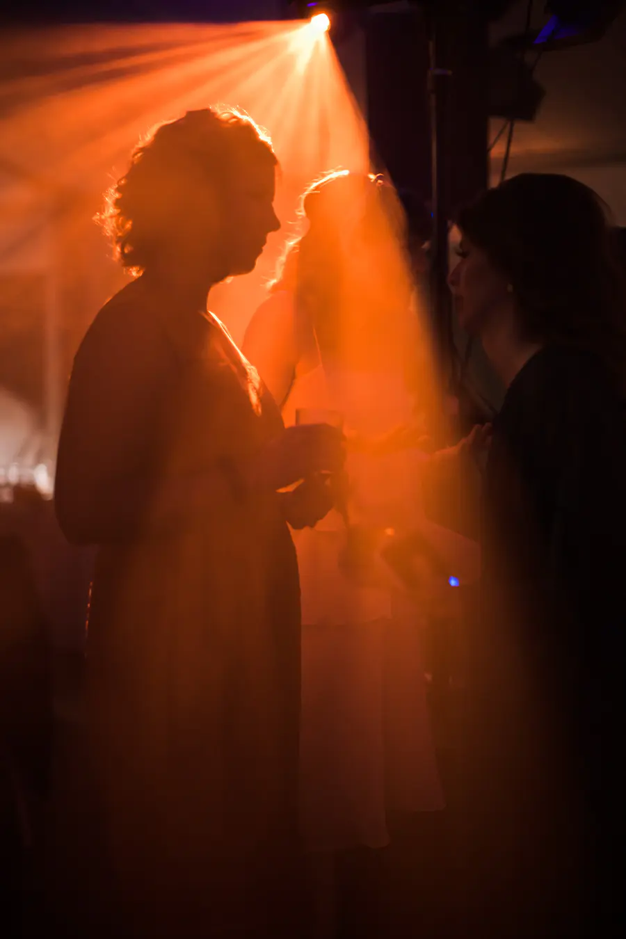 Atmospheric night shot of the wedding party in the tent at Kastiel Tomasov, documentary style.