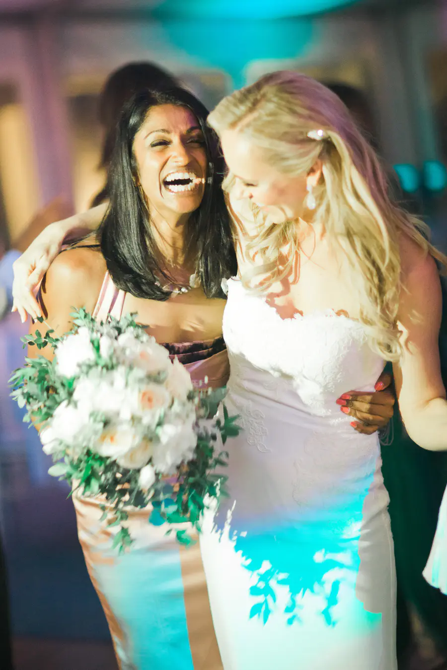 Candid reaction of a guest catching the wedding bouquet, fun and joyful wedding moments.