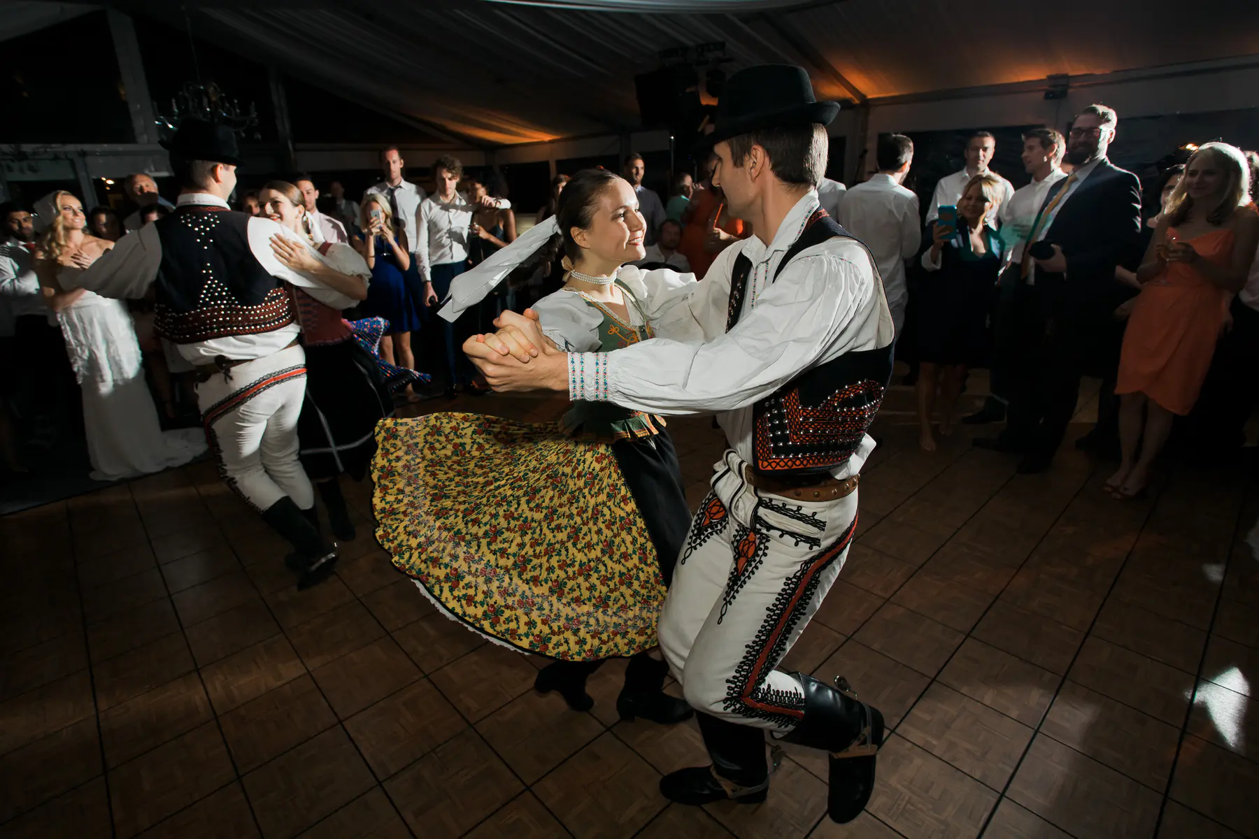 Traditional folk dancers performing during the midnight ceremony at a manor house wedding.