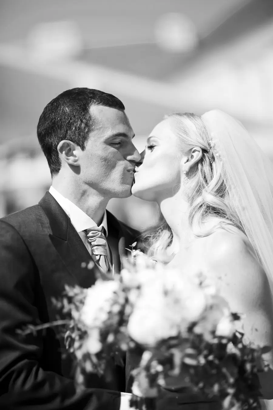 Romantic first kiss of a newlywed couple at an outdoor ceremony in Tomášov, Slovakia.