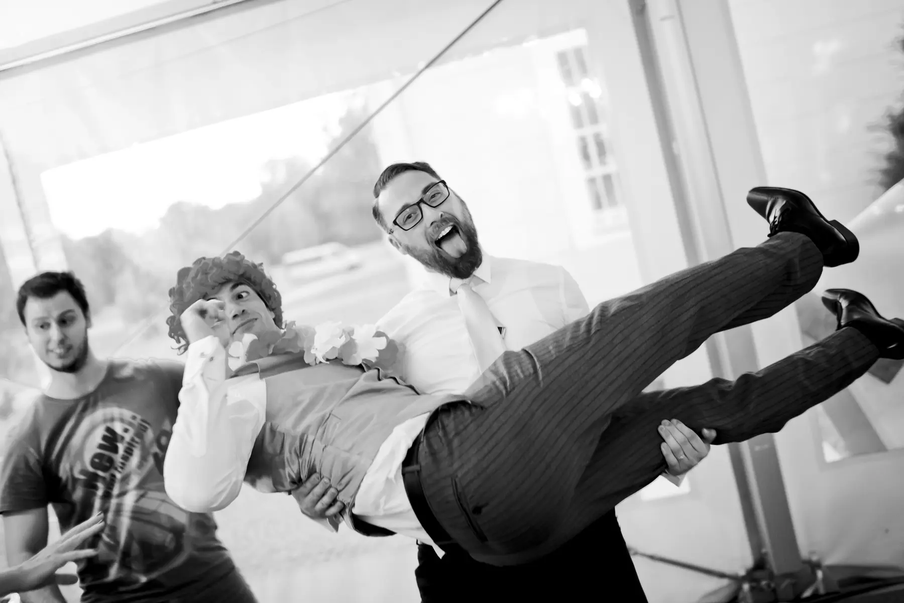 oyful moment of guest lifting the groom during the wild wedding party.