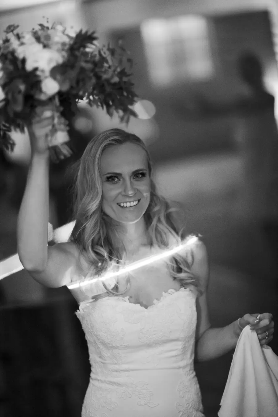 Bride going to toss her bouquet during the night party.