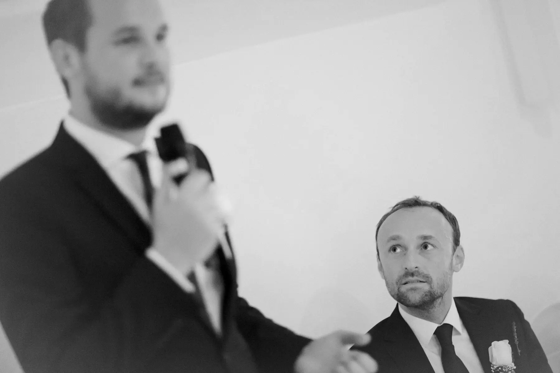 Emotional wedding speeches, groom looking at bestman